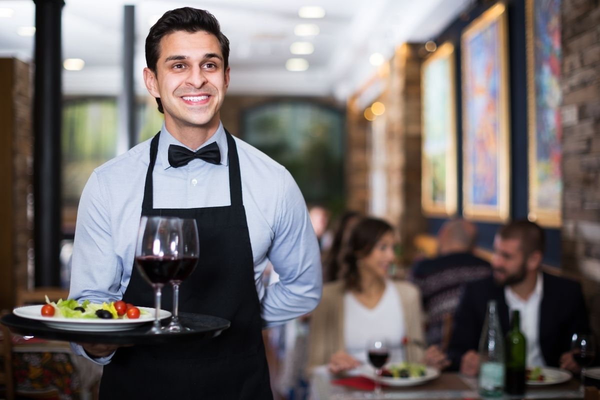 Restaurant owner tracking margins on laptop
