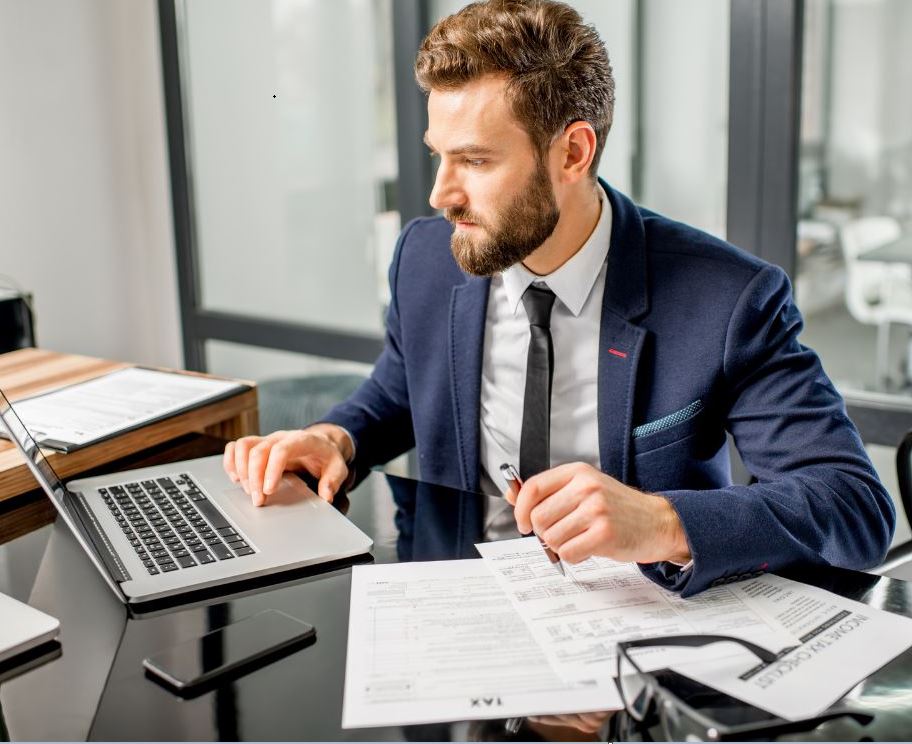 Professional helping an individual prepare tax documents